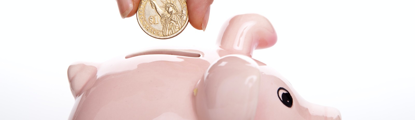 piggy bank with a coin being dropped in