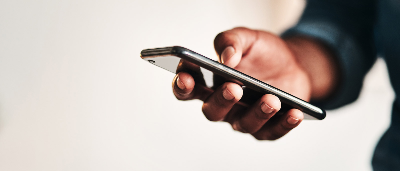 Close up of hand holding phone